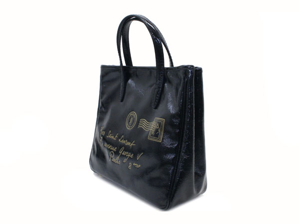 black shopping bag with gold foil writing