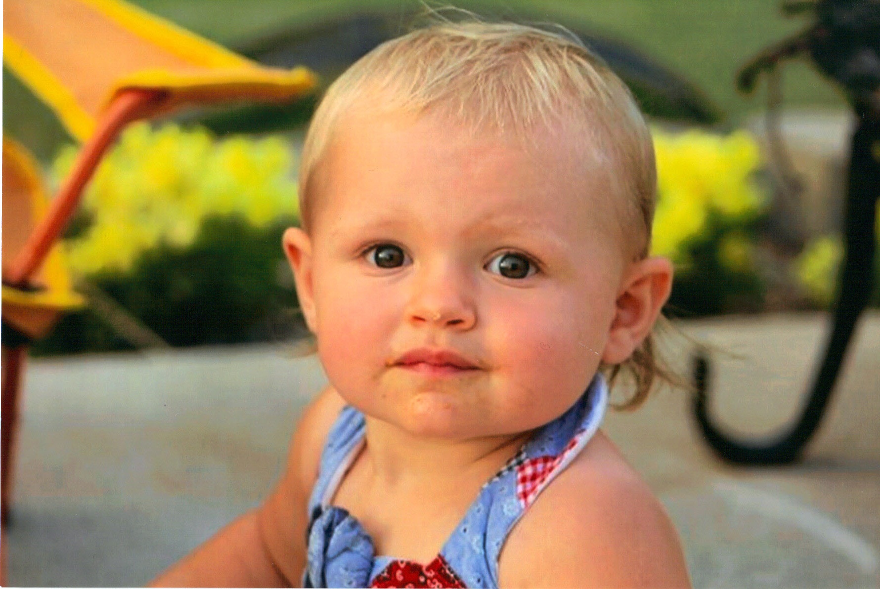 the toddler is wearing a red and blue tie