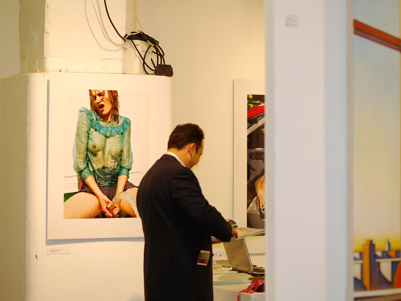 an employee inspects a po of a woman on the wall