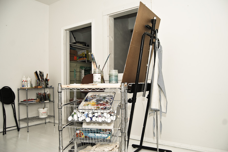 a drawing easel and stand with a canvas and artist's art supplies