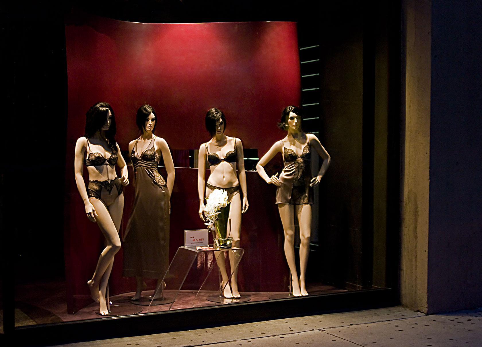 a display case showing three mannequins standing next to each other