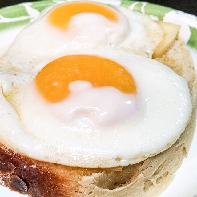 two fried eggs on bread are pictured on a plate