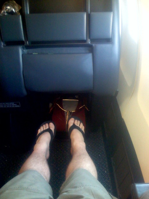 the legs of a person sitting in an airplane