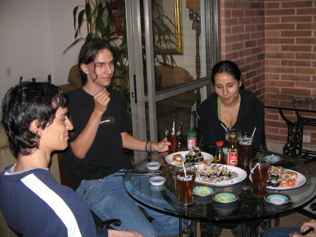a group of people sitting at a table sharing dinner