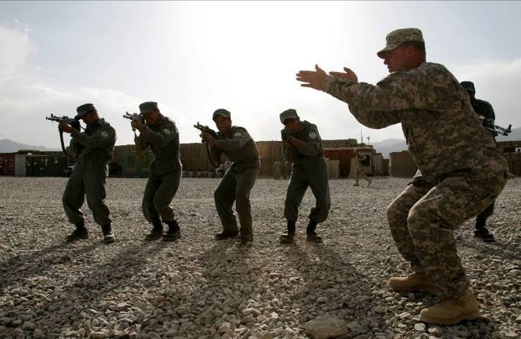 several military men in action in an open area