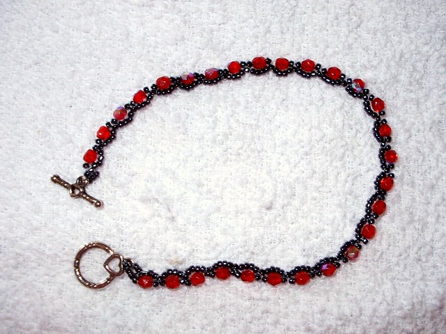 this beaded celet is made of dark glass beads