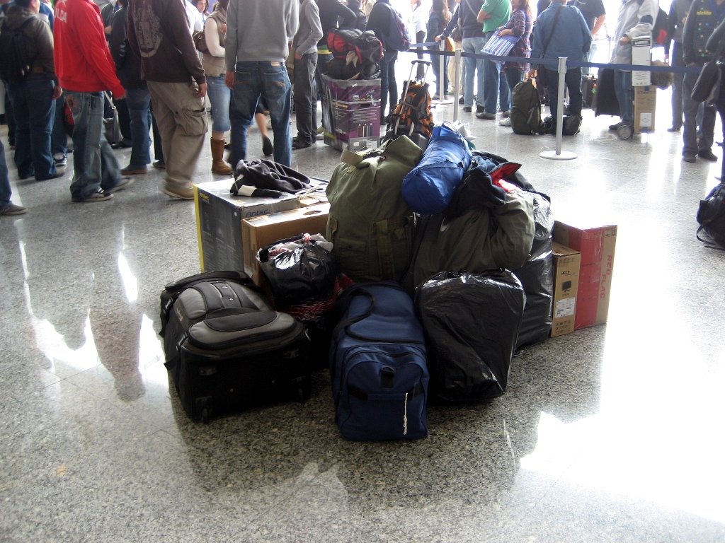 a luggage pile piled up in front of passengers