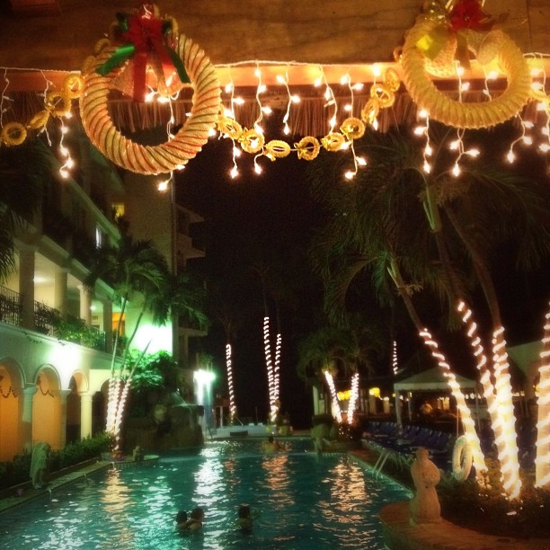 large decorations over a swimming pool decorated with christmas lights