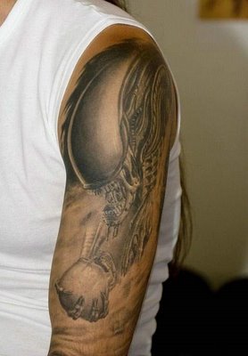 the arm of a woman with an alien tattoo