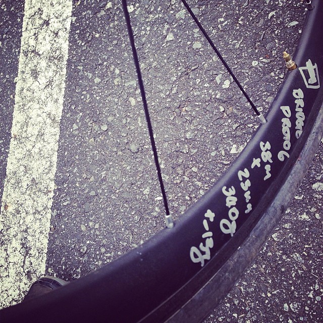 a tire on a street with graffiti on it