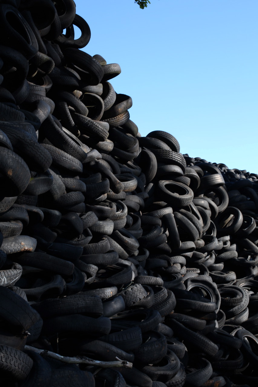 a large pile of used tires on display