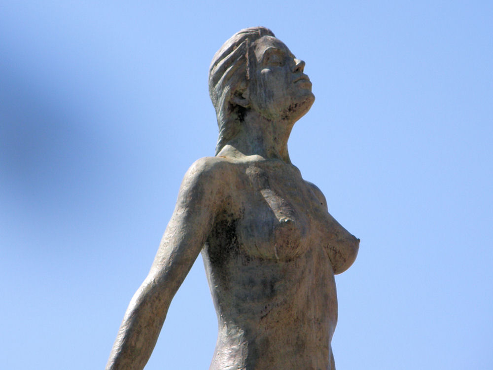 a statue of a woman with hands in her hair