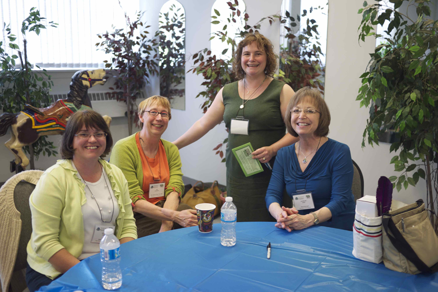 a group of women smiling at a table