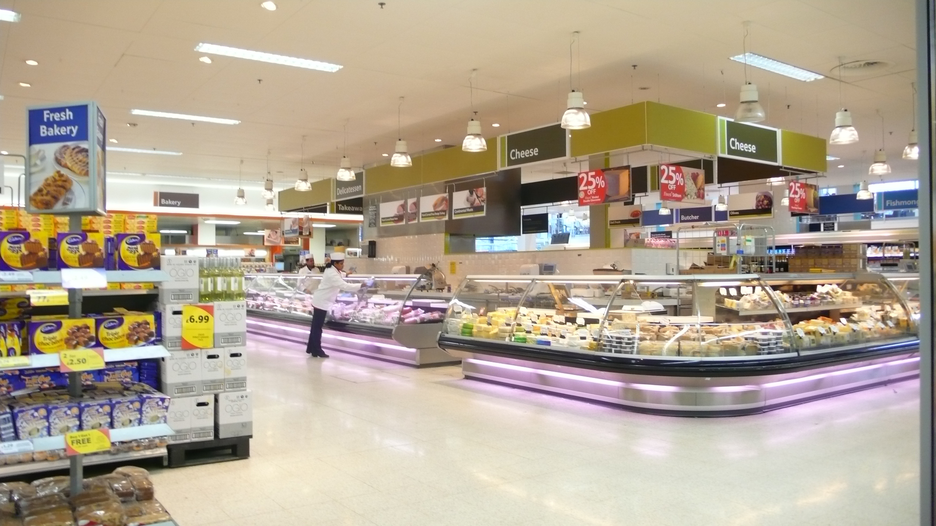 a food market is shown with many varieties of bread