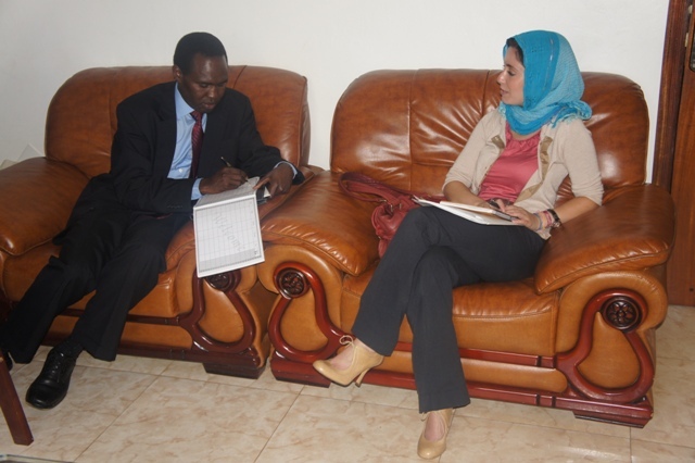 a man in business attire sitting next to a woman