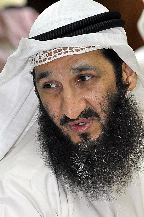 a man with a black headpiece and a beard