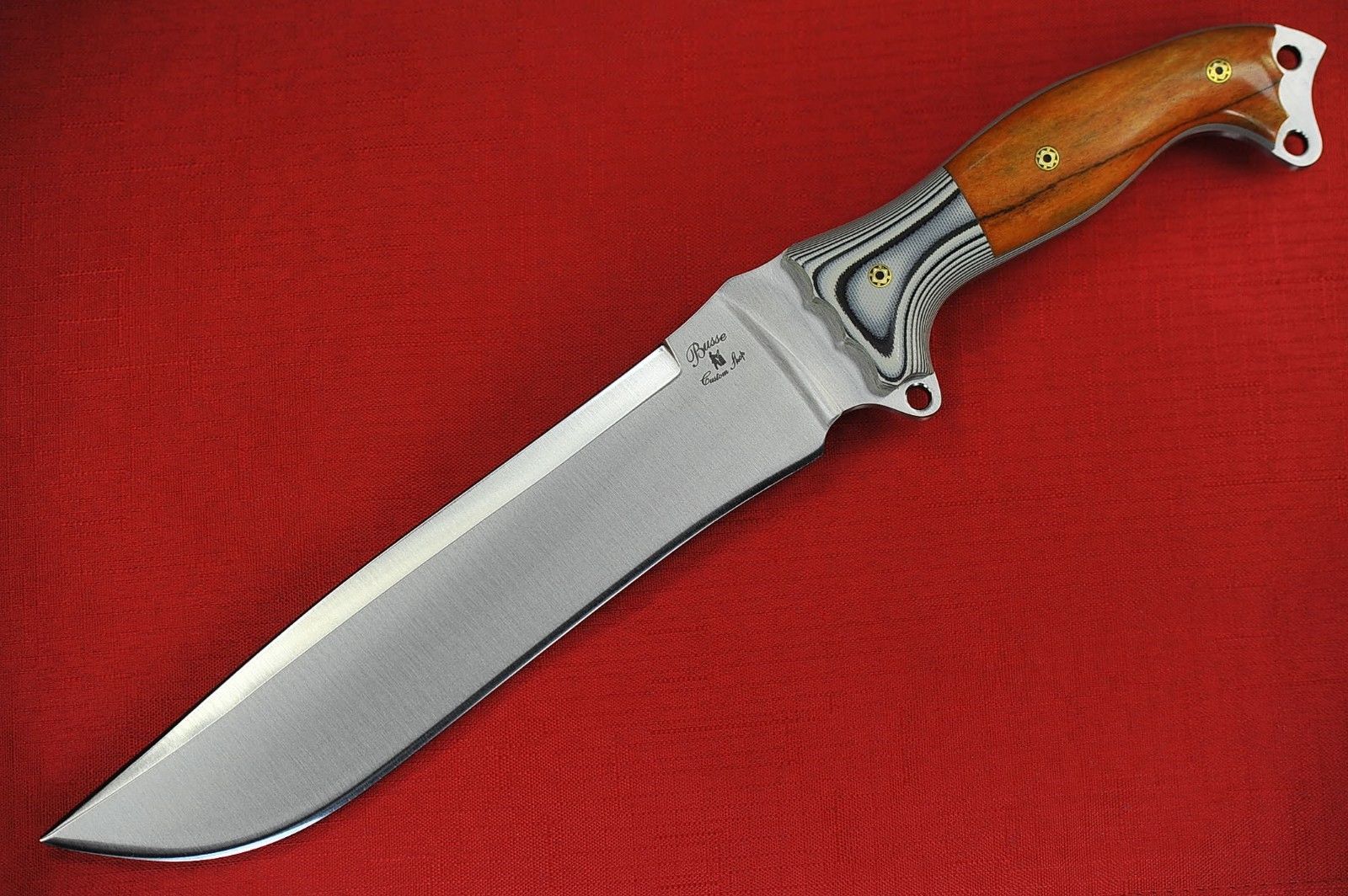 a very nice looking knife on a red cloth