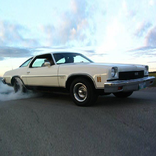 a classic american car in smoke going for a run