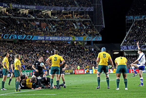 some rugby players on a field and fans