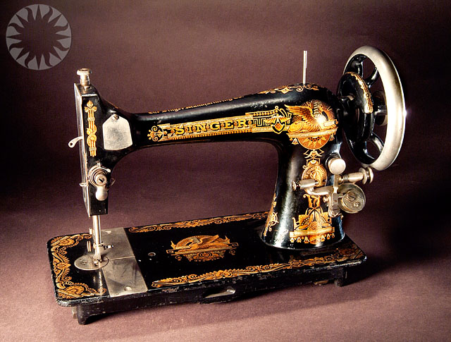 a sewing machine on a black stand and a brown background