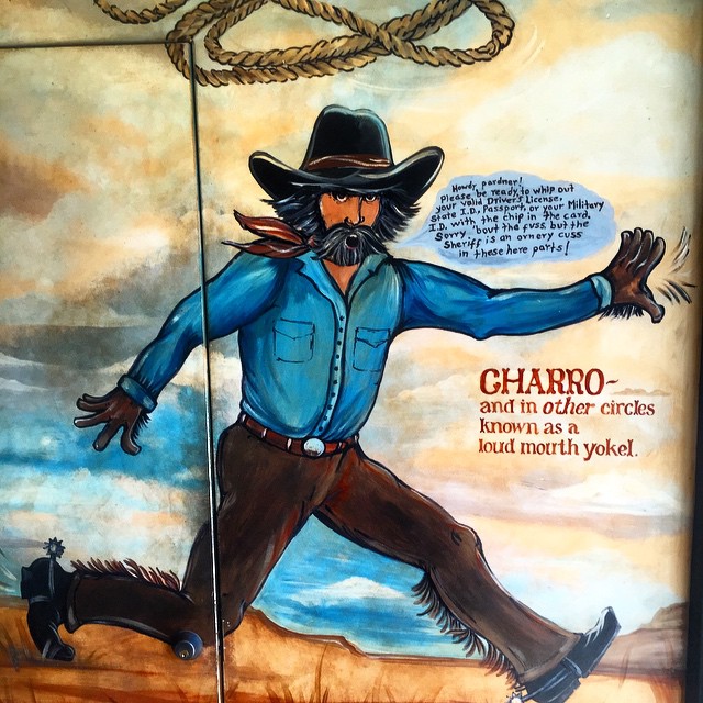 a painted cowboy mural on the wall