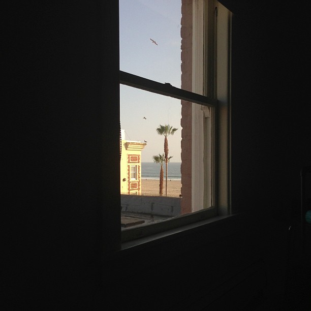 the window shows the view of a beach