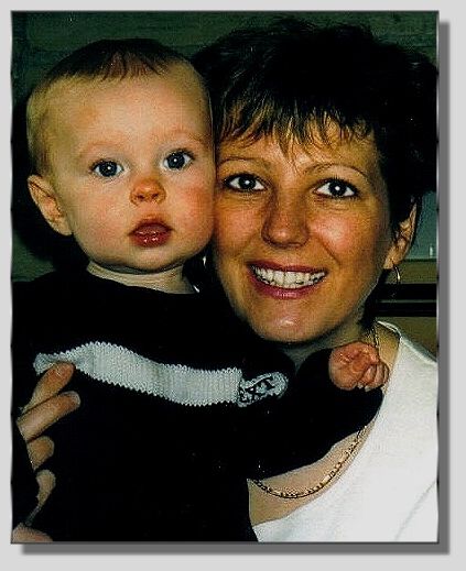 a woman holding a baby posing for a picture