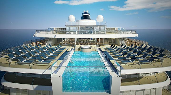 a large pool next to the ocean and an ocean liner with chairs around it