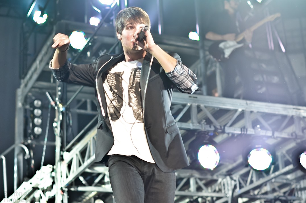 a man on stage with his microphone up