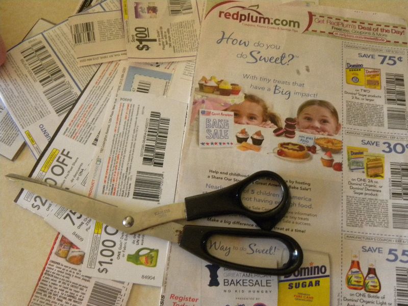 some coupons are next to a pair of scissors