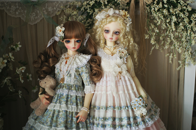 a set of two dolls standing next to each other