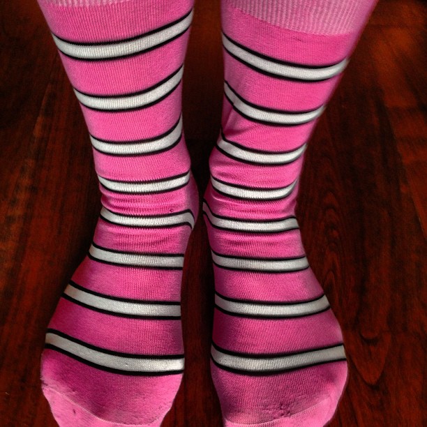 a close up of a pair of pink socks on a floor