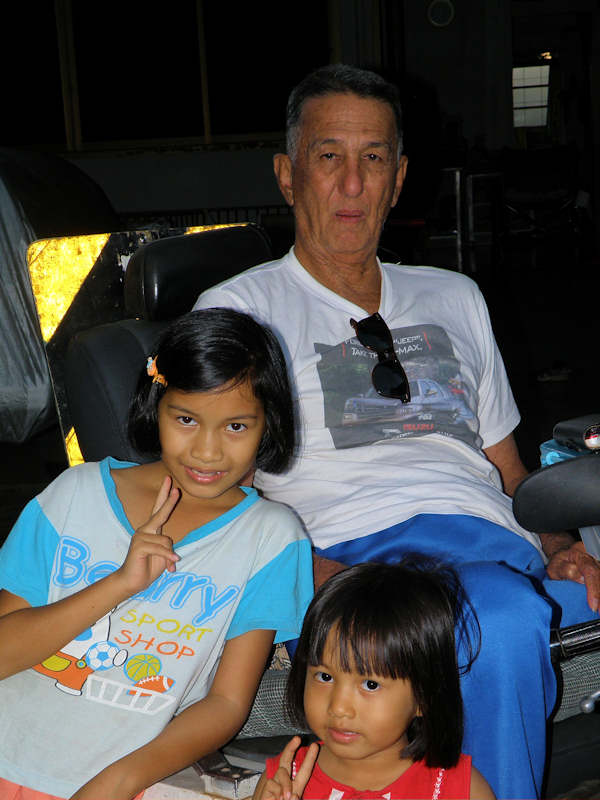 an old man is posing for a po with two little girls