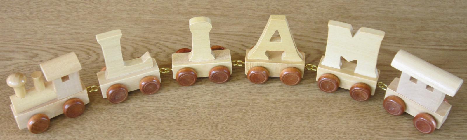 wooden toy train pieces arranged in shape and writing learn