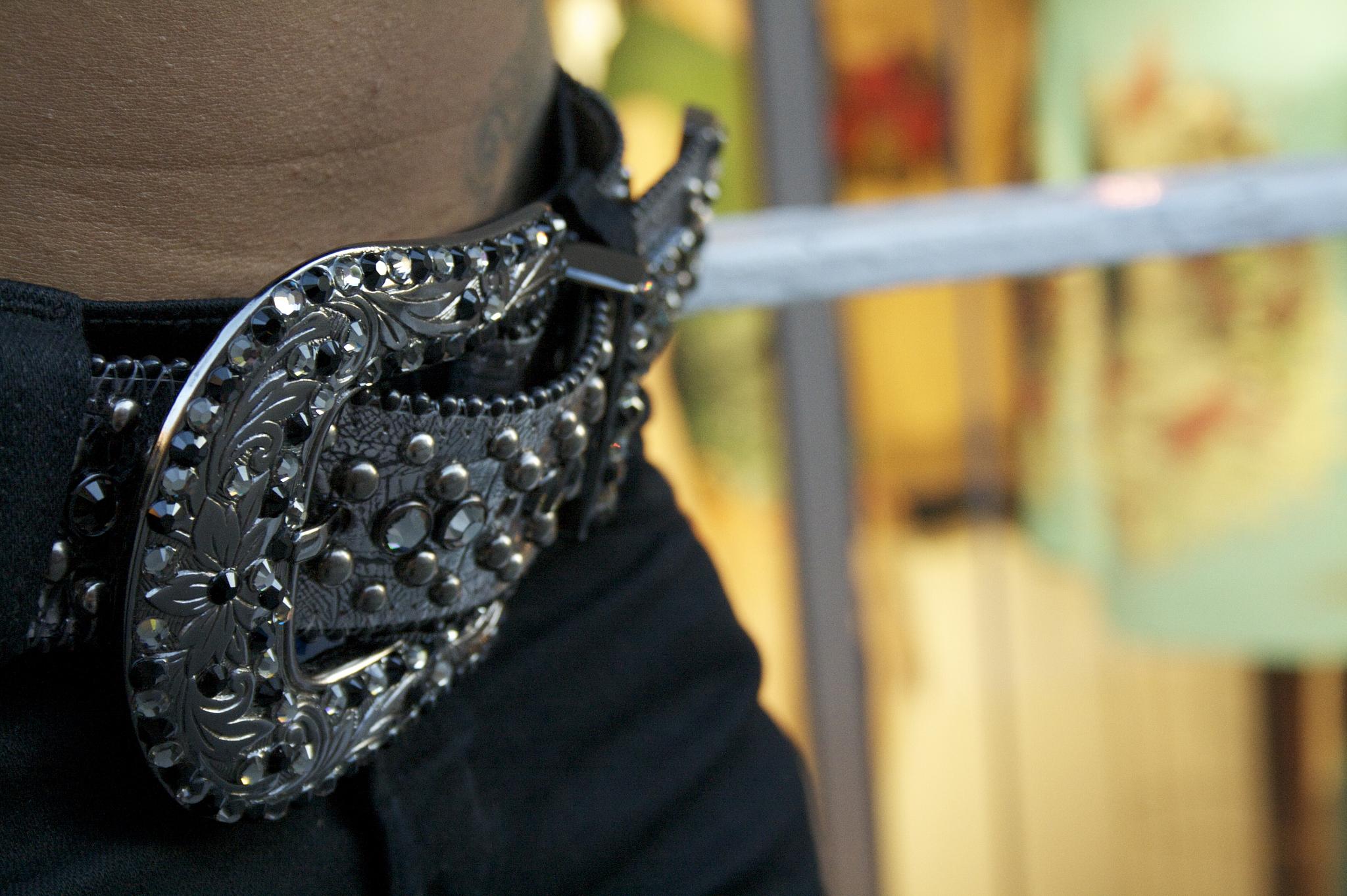 a close up view of a man's belt and jeans