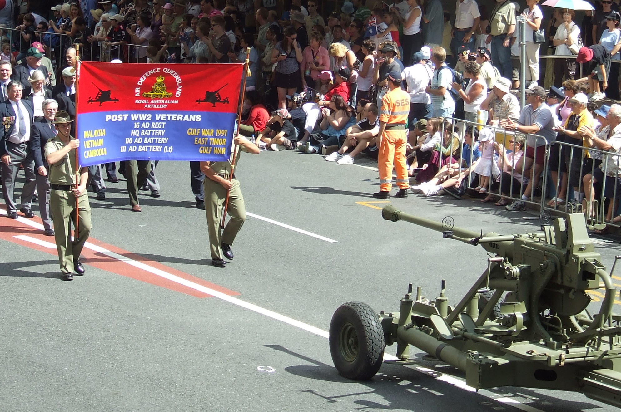 some soldiers are walking down the street carrying a banner