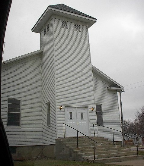 a white building with a steeple and windows