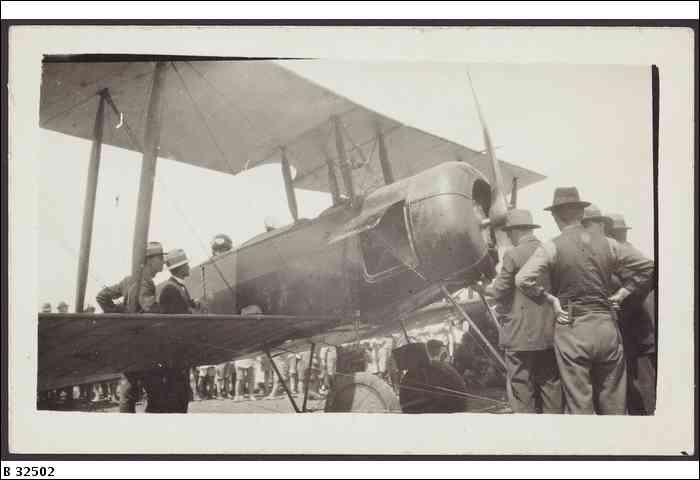 an old po of men with hats walking to an aircraft