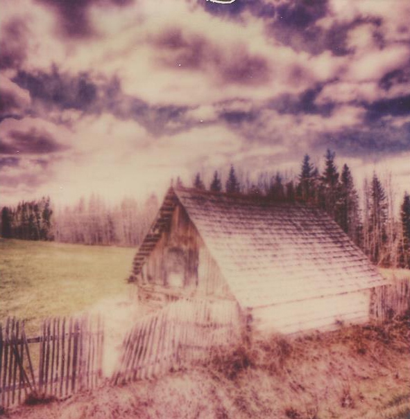 a picture of a wooden cabin is shown on the side of a hill