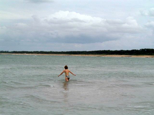 a young woman wading in the ocean water