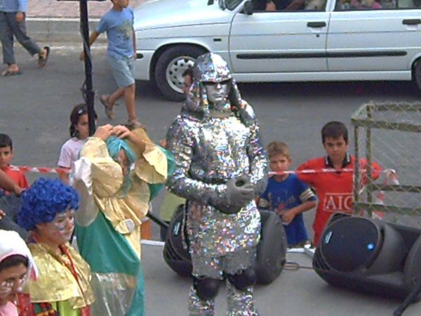 a group of children dressed up as people on the street