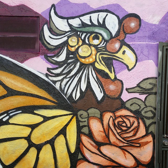 the mural depicts a rooster and a yellow rose