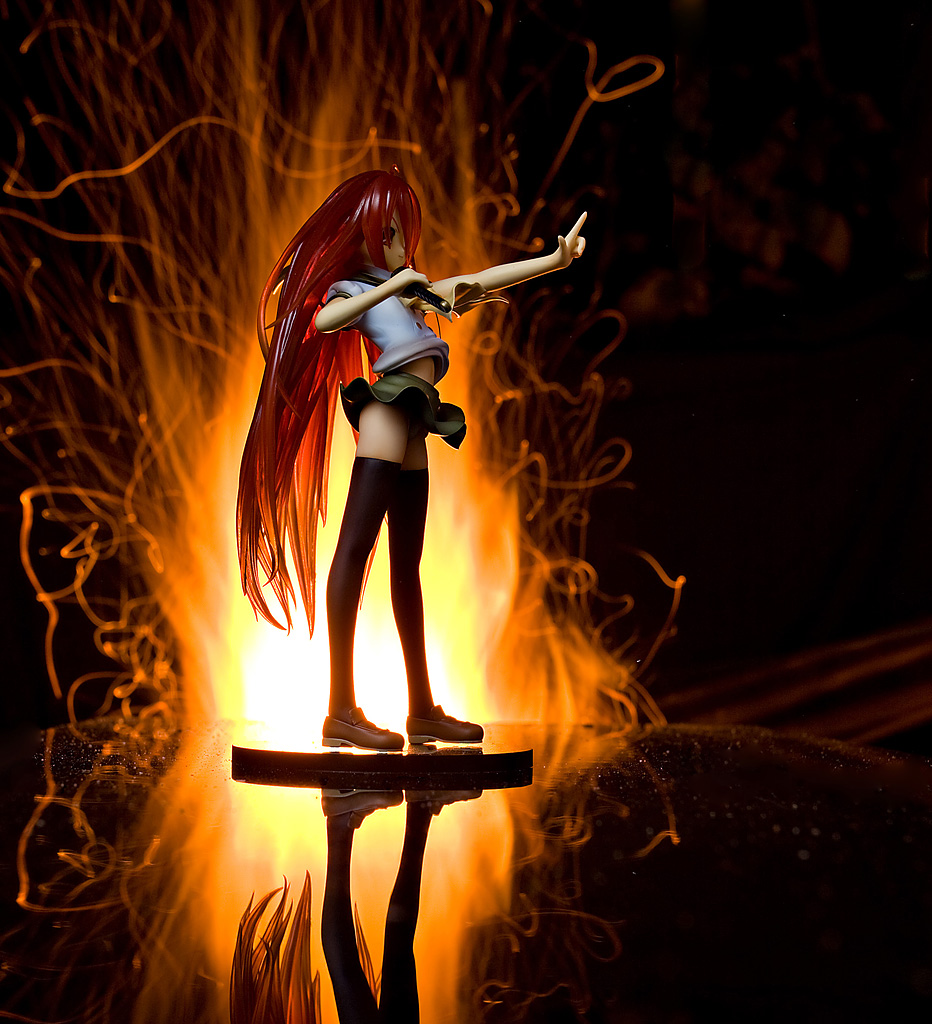 the statue depicts a figure with red hair standing in front of a fire