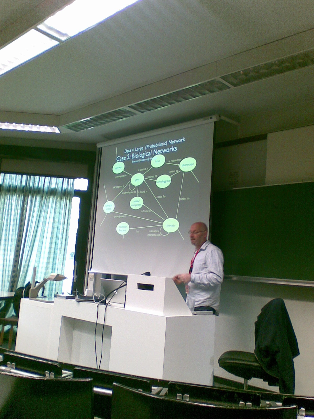 a man is giving a presentation on the projector screen