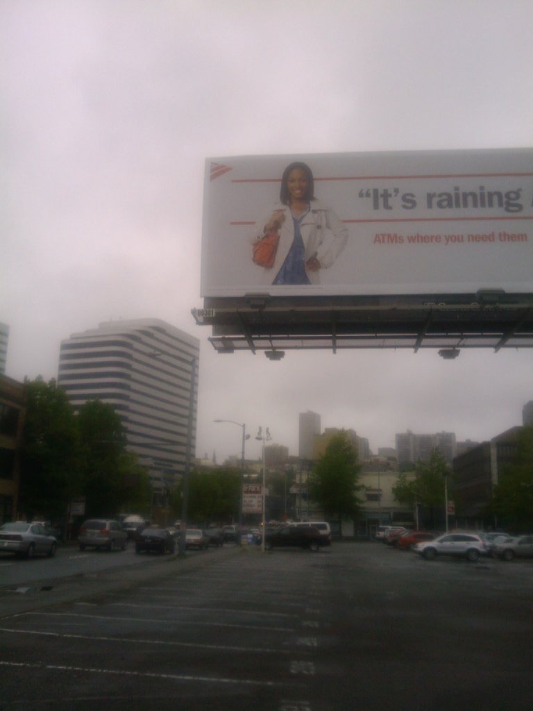 a large billboard featuring an african woman on the side of a street