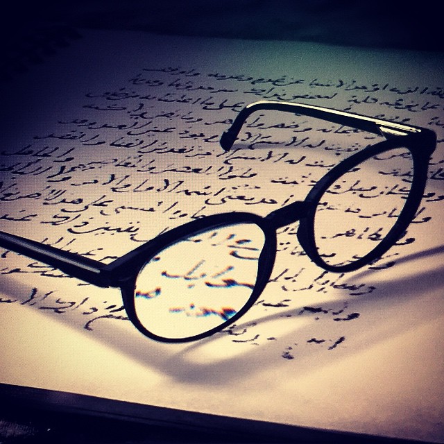 a pair of eyeglasses sits on a piece of paper