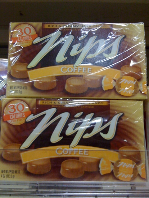 three boxes of nips coffee sit in a store
