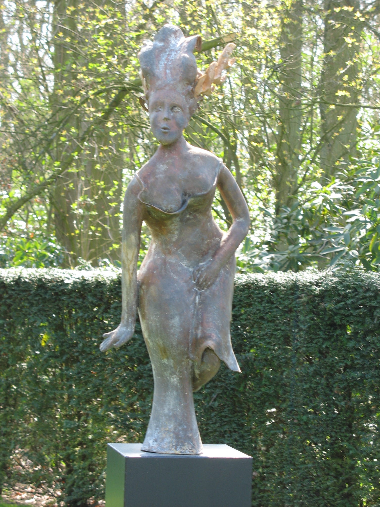 a sculpture of a woman in a bathing suit holding her hand on her hips