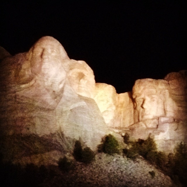 the statue is glowing on the rocks outside