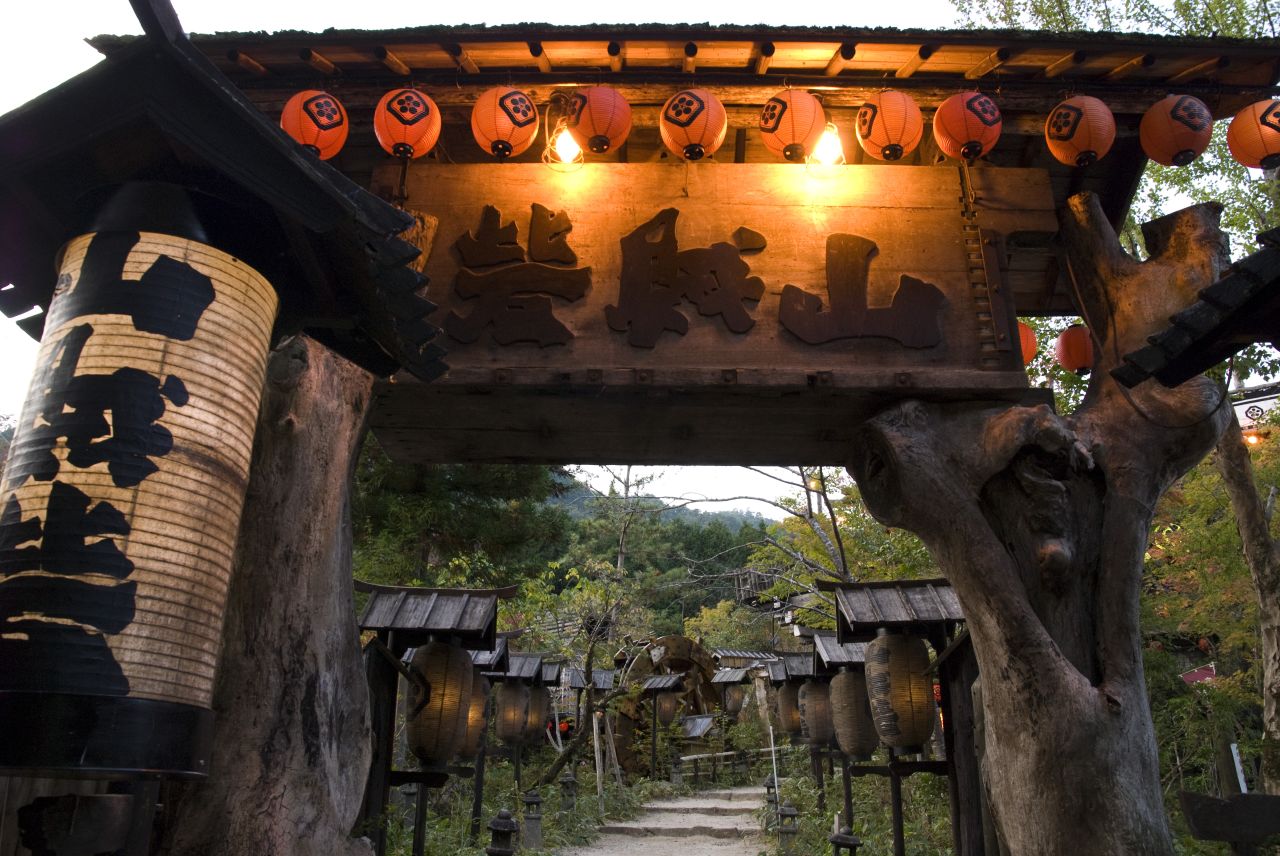 an oriental shrine with decorations on it and a lit walkway